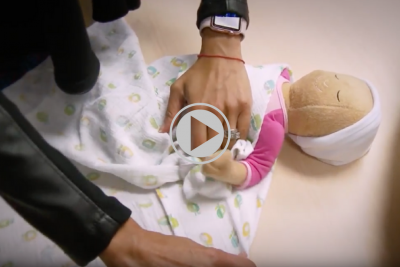 Dr. Jagruti Anadkat a newborn medicine specialist displays how to swaddle a newborn baby in a blanket