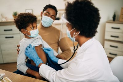 医生检查孩子的肺部以确保他们的健康，而父母则在一旁观察